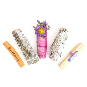 Smudge Kit With Two White Sage Smudge Sticks, One Floral Smudge Stick, One Palo Santo Stick With Rainbow Aura Purple Quartz, and One "I Am Still Learning" Engraved Palo Santo Stick.
